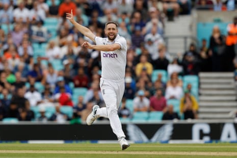 England's Chris Woakes celebrates after taking the wicket of Australia's David Warner.