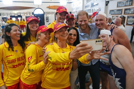The Duke and Duchess of Sussex pose for a selfie photo as they meet volunteer first responders from Bondi Surf Bathers’ Life Saving Club during a visit to Bondi beach