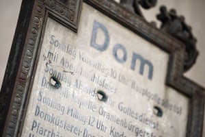 Bullet holes in a notice showing service times at the prominent Berliner Dom (church)
