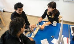 Mentor guiding student during the Towers of Hanoi at the Guardian Coding Workshop