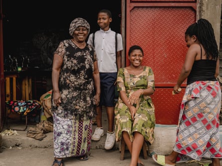 Three women and a boy stand outside a building.