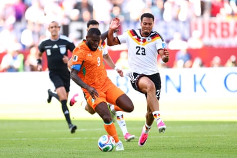Franck Kessié #8 of Cote d'Ivoire controls the ball against Felix Nmecha