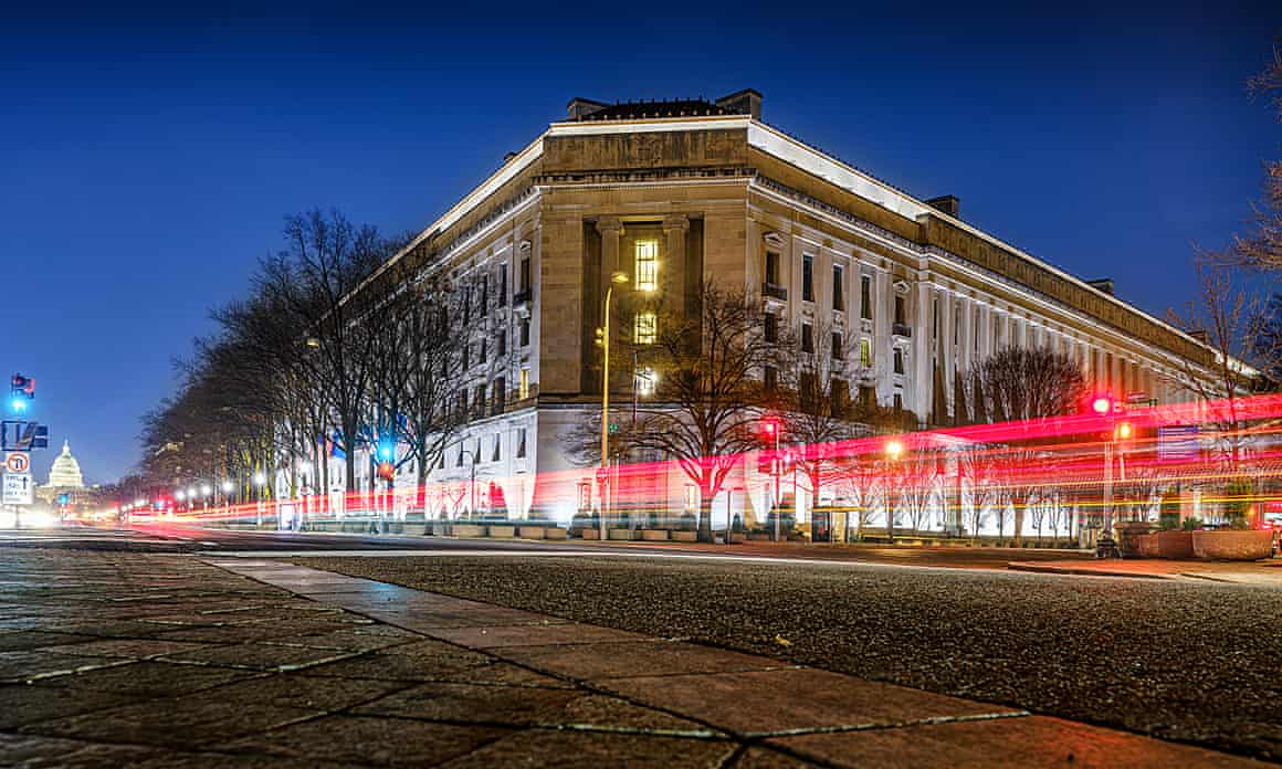Traffic streaks by the Department of Justice headquarters