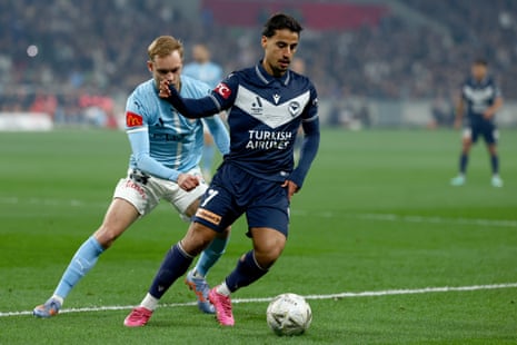 Victory’s Daniel Arzani controls the ball under pressure from City’s Nathaniel Atkinson.