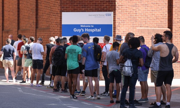 People queue for monkeypox vaccinations at Guy’s Hospital in London on Sunday.