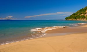 An empty sandy beach and azure sea