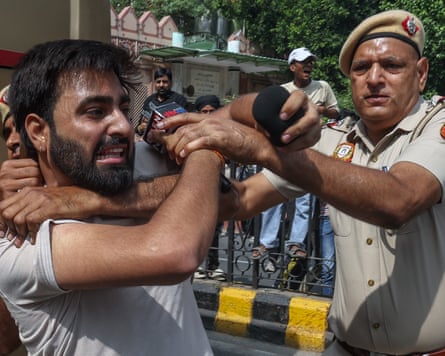 A protester is detained.