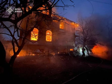 Ukrainian firefighters work on site to extinguish a fire in Kyiv