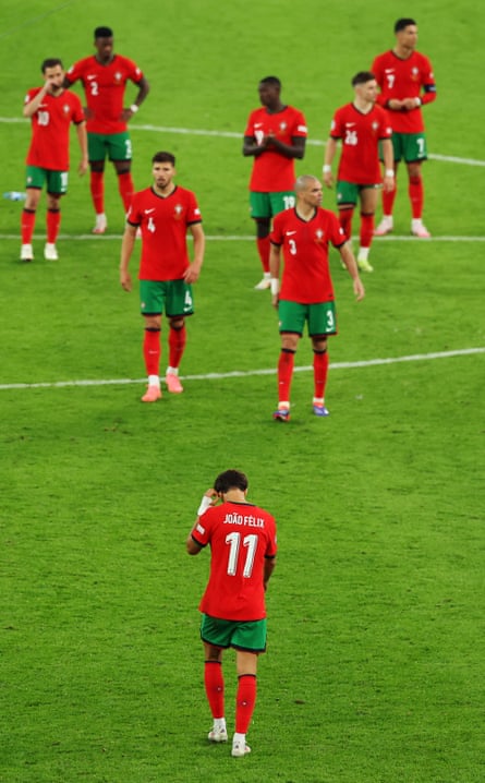The Portuguese squad head towards the distraught João Félix after his miss
