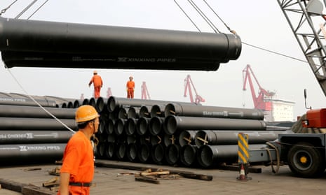 Workers in China loading huge steel pipes