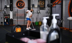 A Sydney gym employee prepares to reopen.