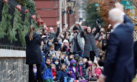 Joe Biden waves to children in Washington DC  Wednesday.