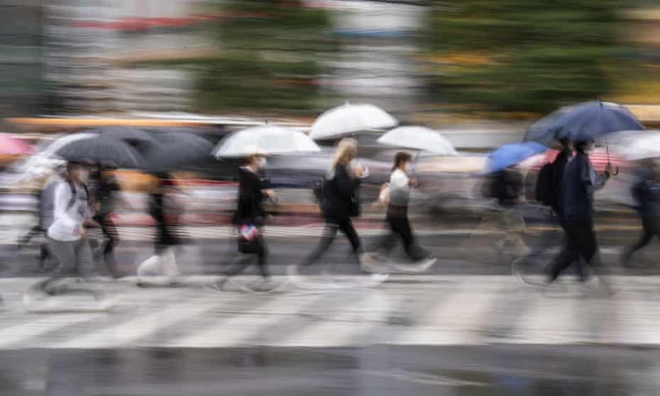 Commuters crossing a road, taken with a slow-shutter speed exposure