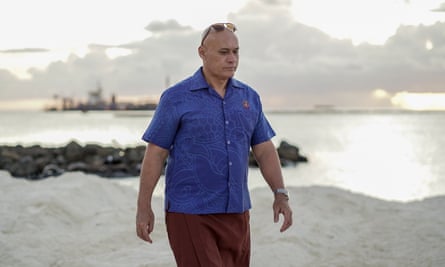 Seve Paeniu walks along the foreshore where land reclamation is taking place