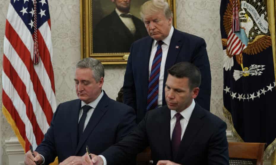 The acting US homeland security secretary, Kevin McAleenan, and the interior minister of Guatemala Enrique Degenhart sign an agreement in the Oval Office, 26 July 2019.