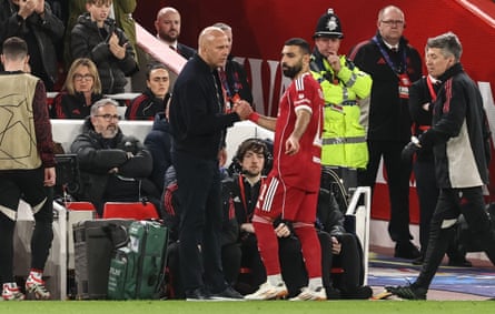 Arne Slot, manager of Liverpool, shakes hands with Mohamed Salah of Liverpool after Salah is substituted during the UEFA Champions League last 16 second leg match between Liverpool and Galatasaray at Anfield