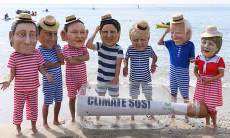 Oxfam campaigners pose as G7 leaders on Swanpool Beach near Falmouth, Cornwall.