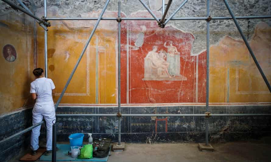 Experts work on the inner and outer walls of the reopened hot rock pile in Pompeii