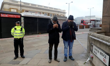 Sabah Ahmedi and Mansoor Clarke, imams of the Ahmadiyya Muslim Community, pray to mourn the victims at the scene of a stabbing on London Bridge.
