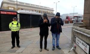 Sabah Ahmedi and Mansoor Clarke, imams of the Ahmadiyya Muslim Community, pray to mourn the victims at the scene of a stabbing on London Bridge.