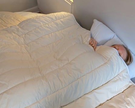 The writer’s head peeks out of the top of the Floks Wool Winter Plus double duvet.