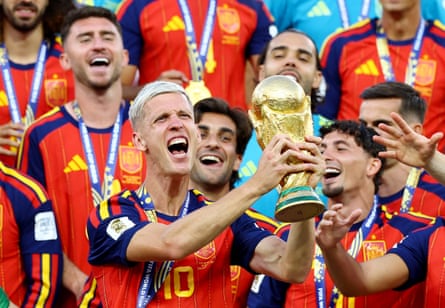 Dani Olmo lifts the trophy with teammates after winning the World Cup Dani Olmo lifts the trophy with teammates after winning the World Cup