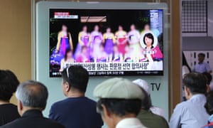 A TV screen shows a blurred photo of North Korean restaurant workers in China, during a news programme at the Seoul railway station.
