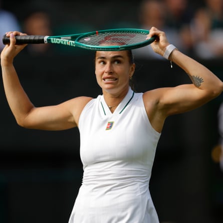 Aryna Sabalenka puts her racket on her head