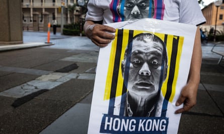 A man holds a poster of Jimmy Lai