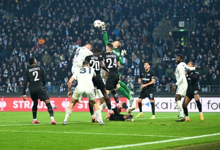 Sturm Graz’s goalkeeper, Oliver Christensen, gets his hand to a cross.