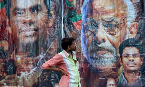 A man stands in front of a poster featuring PM Modi and Bharatiya Janata Party election candidate Annamalai, outside its party office in Chennai, India, 4 June 2024.