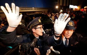 Tokyo, JapanPolice officers make way for a car carrying the former Nissan chair Carlos Ghosn as it leaves his lawyer’s office