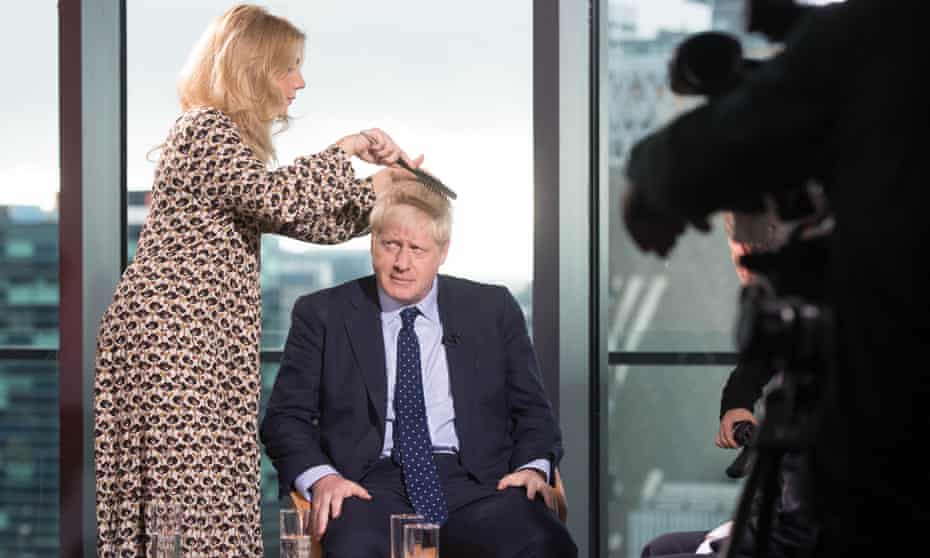 A stylist prepares Boris Johnson to appear on the Andrew Marr show before the Conservative party annual conference in September.
