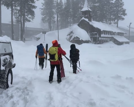 three men walking in snow
