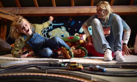 Ben Martin and son Phoenix playing on the 75ft Scalextric track in their loft.