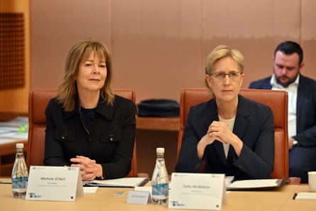 Michele O'Neil and Sally McManus sit at a table with bottles of water and name cards in front of them