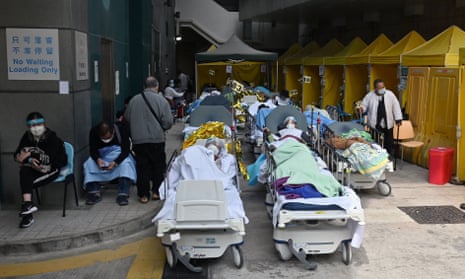 People lie in hospital beds outside Caritas Medical Centre in Hong Kong, as the city faces its worst coronavirus wave to date.