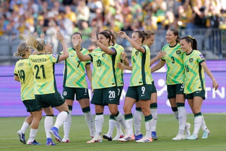 Sam Kerr congratulated by teammates after scoring.