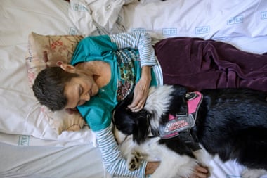 A woman caresses a therapy dog in Markhot Ferenc hospital, Hungary