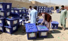 Election workers move ballot boxes to an Independent Election Commission warehouse on Sunday.