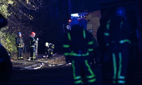Ukrainian firefighters intervene at the scene where a Russian missile fragment fell near a residential building in Kyiv.