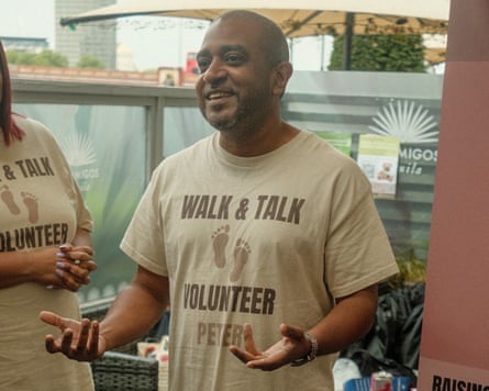 Peter Reeves in mid-conversation, wearing a top that reads ‘Walk & Talk Volunteer Peter’.