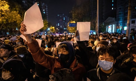 Protesters holding up pieces of paper against censorship and China's strict zero Covid measures in Beijing today.
