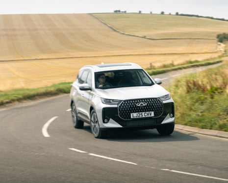 Chery car driving down road.