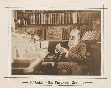 An archival photo of a man with a beard in a room full of books