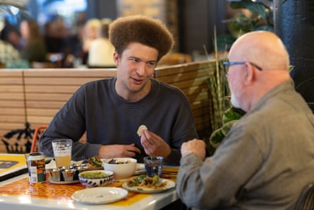 Alex and Mike chatting across a restaurant table