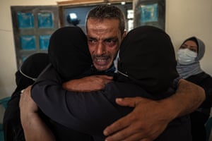 Relatives of Palestinian Omar al-Nile, 12, who was shot during a demonstration on the eastern border between Gaza and Israel, mourn during his funeral.