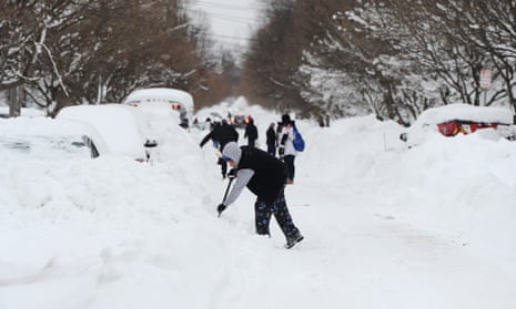 At Least 28 Dead After Historic Buffalo Blizzard That Has Paralyzed The City<br>BUFFALO, NY - DECEMBER 27: Residents on Woodside Drive clear heavy snow on December 27, 2022 in Buffalo, New York. The historic winter storm Elliott dumped up to four feet of snow, leaving thousands without power and at least 28 confirmed dead in the city of Buffalo and the surrounding suburbs. (Photo by John Normile/Getty Images)