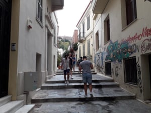 Tourists walking through the streets of ancient Plaka in Athens.