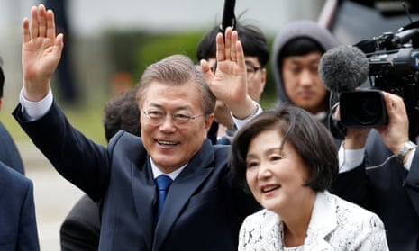 South Korean Moon Jae-in and his wife Kim Jung-sook wave to well-wishers as they arrive at the presidential Blue House in Seoul on Thursday.